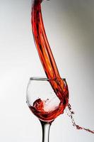 Wine splash into glass photo
