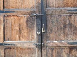 Old wooden door and locked key photo