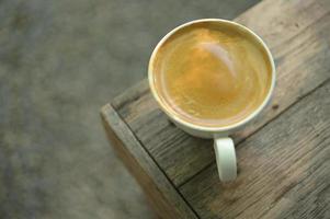 Hot coffee, americano coffee, caffeinated beverage, crema coffee, close-up shot. photo