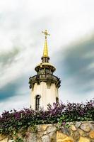 Christian church cross in high steeple tower for prayer photo