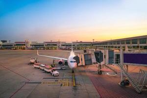 Airport ramp service for for a commercial plane landing at Suvarnabhumi International Airport in Bangkok,Thailand photo