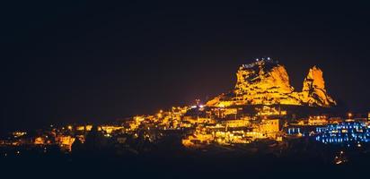 Panoramic landscape of Uchisar castle at night in Cappadocia, Central Anatolia, Turkey, Asia. Panoramic banner portion photo