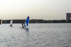 Standup paddleboarding are on the river Moscow, Strogino. photo