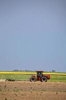 Saskatchewan farmer plowing his field photo