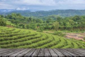 Empty wooden floor with blurred tea plantations Can be used for product display editing photo