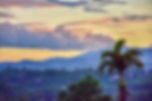 The blurred view of the mountains against the beautiful backdrop of the colored sky and clouds. photo