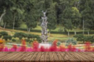 wooden table top on blurred park background photo