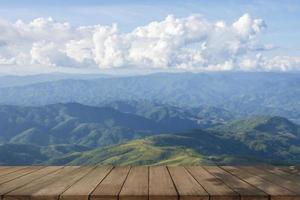 wooden table and beauty blur sky and mountains as background photo