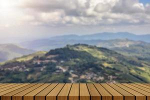 wooden table and beauty blur sky and mountains as background photo