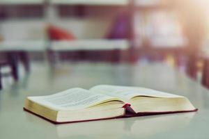 Open book on the table in library photo