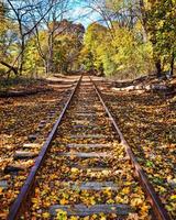 Abandoned railroad track in fall photo