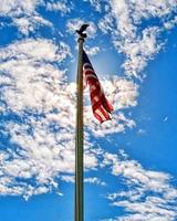 American flag with a ray of sunlight behind photo