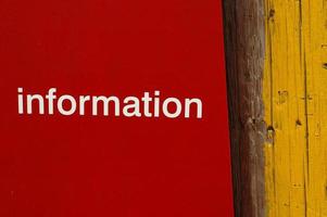 information text on red and yellow wooden background photo