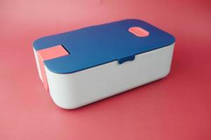 top view of a lunch box on color background photo