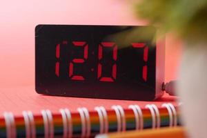 digital clock on red background top down photo