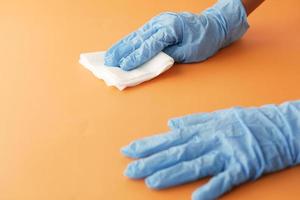 close up of person hand cleaning table with cloth photo