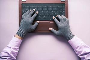 hacker hand stealing data from laptop top down photo