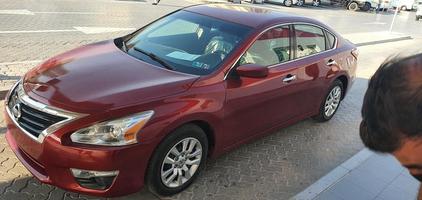 Dubai, UAE April 2022, Nissan altima red color car front side view photo