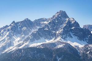 Idyllic view of majestic kronplatz mountain range against clear blue sky photo