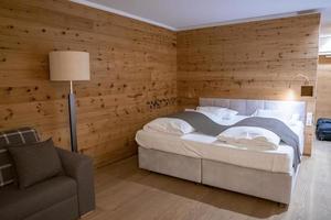 Interior of cozy rustic style bedroom in luxurious ski resort photo