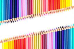 Multi-colored wooden sticks Wooden colouring pencils on white background photo