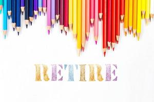 Multi-colored wooden sticks Wooden colouring pencils and Retire on white background photo