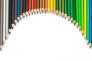 Multi-colored wooden sticks Wooden colouring pencils on white background photo