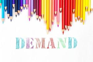 Multi-colored wooden sticks Wooden colouring pencils and Demand on white background photo