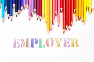 Multi-colored wooden sticks Wooden colouring pencils and Employee on white background photo