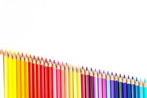 Multi-colored wooden sticks Wooden colouring pencils on white background photo