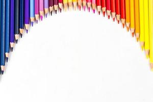 Multi-colored wooden sticks Wooden colouring pencils on white background photo