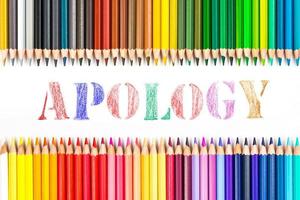 Multi-colored wooden sticks Wooden colouring pencils and apology on white background photo