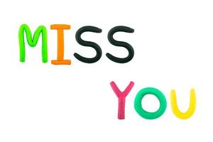 message miss you Funny plasticine alphabet letters on white background photo