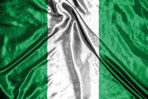 bandera de tela de nigeria bandera de satén ondeando la textura de la tela de la bandera foto