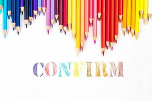 Multi-colored wooden sticks Wooden colouring pencils and Confirm on white background photo