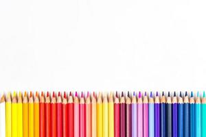 Multi-colored wooden sticks Wooden colouring pencils on white background photo