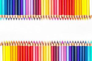 Multi-colored wooden sticks Wooden colouring pencils on white background photo