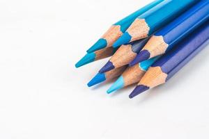 Multi-colored wooden sticks Wooden colouring pencils on white background photo