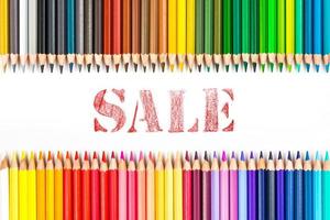 Multi-colored wooden sticks Wooden colouring pencils and sale on white background photo