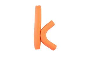 alphabet k English colorful letters Handmade letters molded from plasticine clay on Isolated white background photo
