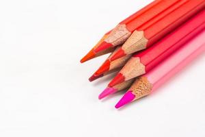 Multi-colored wooden sticks Wooden colouring pencils on white background photo