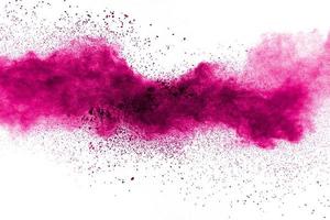 Abstract pink powder explosion on white background. Freeze motion of pink dust splattered. photo