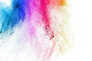 Multicolored powder explosion on white background.Launched colorful particle on background. photo