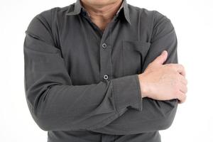 Portrait of businessman cross hand to show confidence isolated on white background photo