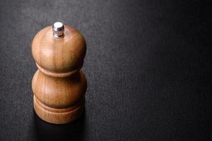 Salt or pepper shakers on black cncrete table. Space for text photo