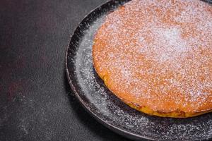 Pumpkin pie, tart made for Thanksgiving day with whipped cream on a black plate photo