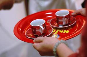 Close up of the hands of bride and groom holding a tea set during a Chinese wedding tea ceremony photo