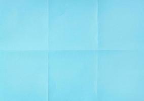 Blue crumpled unfolded paper sheet texture background. Paper folded in six. Full frame photo