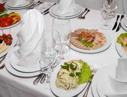 served table with crockery and food photo