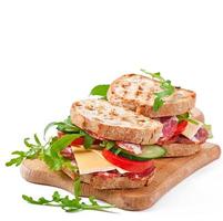 Sandwich with ham, cheese and fresh vegetables photo